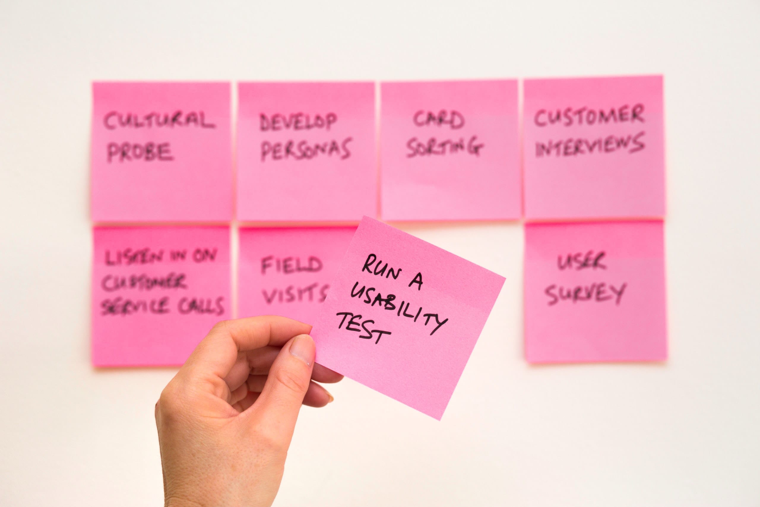 pink post it notes on a wall